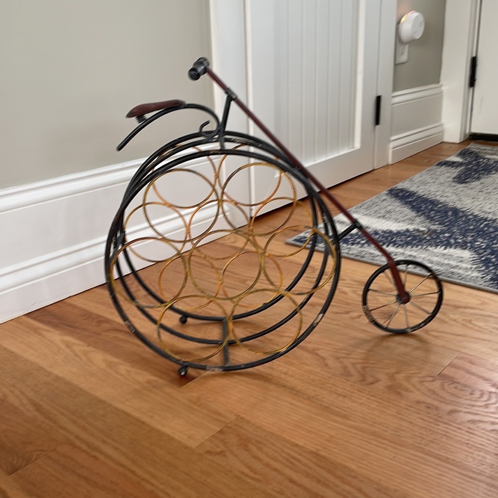Bicycle metal framed wine rack, holds 7 bottles.